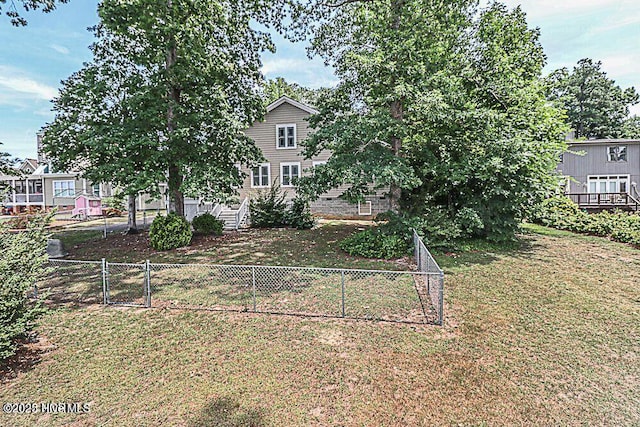 view of front of property with a front yard, fence, and a gate