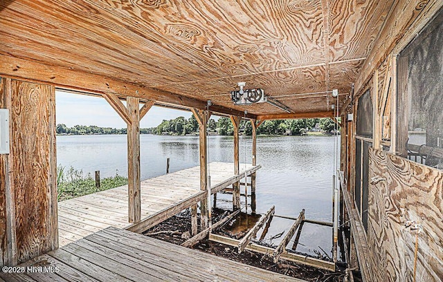 view of dock with a water view, boat lift, and electric panel