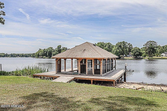 view of dock featuring a water view and a yard