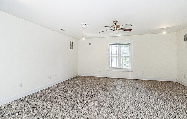 empty room featuring visible vents, ceiling fan, and baseboards