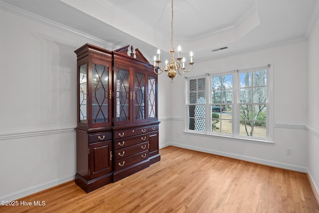 126 Francis Marion Dr, Wilmington, NC 28411 - dining room featuring ornamental molding, a raised ceiling, visible vents, and light wood-style flooring