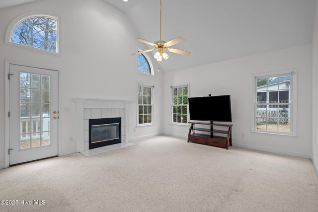 126 Francis Marion Dr, Wilmington, NC 28411 - carpeted living room with high vaulted ceiling, baseboards, ceiling fan, and a tiled fireplace