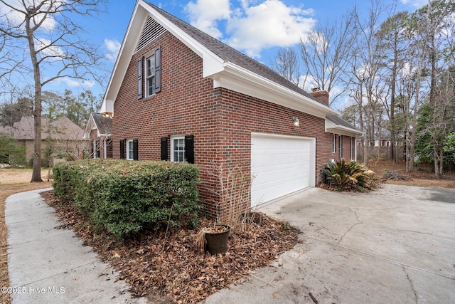 126 Francis Marion Dr, Wilmington, NC 28411 - view of side of home with brick siding, driveway, a chimney, and an attached garage