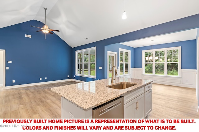 kitchen featuring white cabinetry, light wood-style flooring, a sink, dishwasher, and ceiling fan with notable chandelier