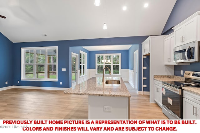 kitchen with a sink, white cabinetry, stainless steel appliances, lofted ceiling, and a chandelier