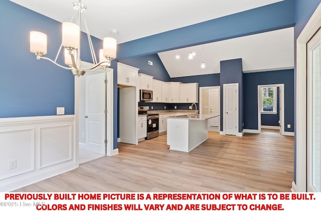 kitchen featuring stainless steel microwave, light wood-type flooring, electric range, a notable chandelier, and a sink