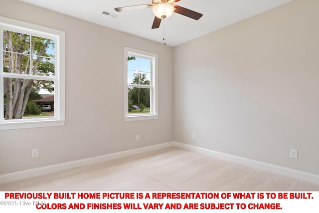 spare room with baseboards, light colored carpet, visible vents, and ceiling fan