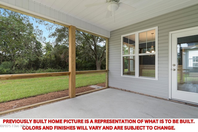 unfurnished sunroom featuring ceiling fan