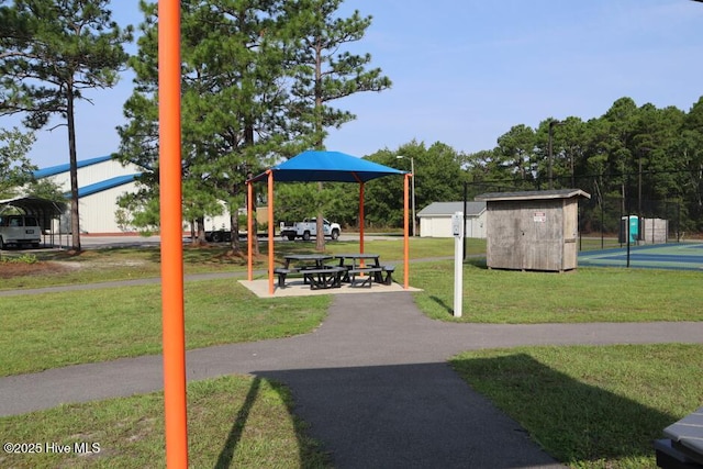 view of home's community featuring an outbuilding, a shed, and a yard