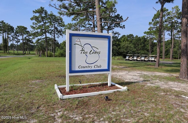 community / neighborhood sign with a lawn