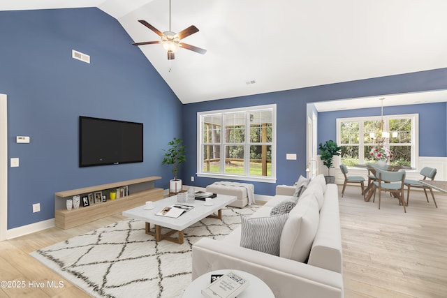 living room with visible vents, wood finished floors, and ceiling fan