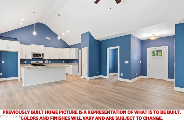 kitchen with white cabinetry, a ceiling fan, light wood-type flooring, and appliances with stainless steel finishes