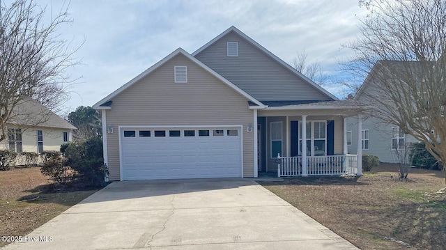 traditional home featuring a porch, driveway, and a garage