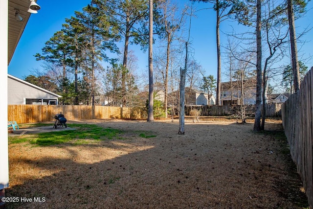 view of yard with a fenced backyard and a patio