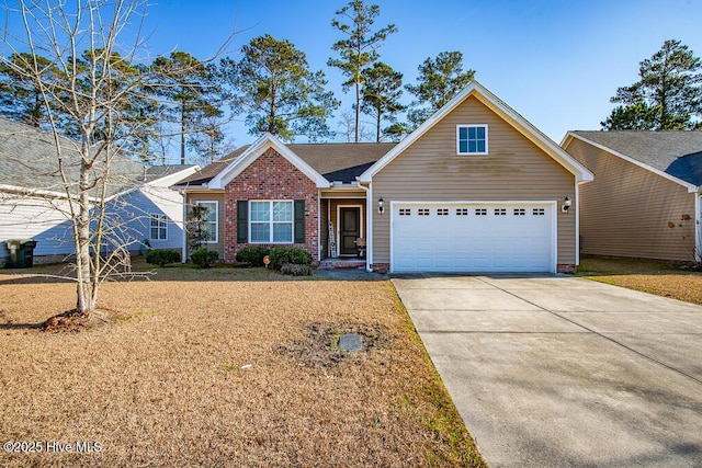 view of front of property with a garage, a front yard, concrete driveway, and brick siding