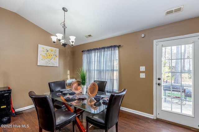 dining space featuring vaulted ceiling, dark wood finished floors, and visible vents