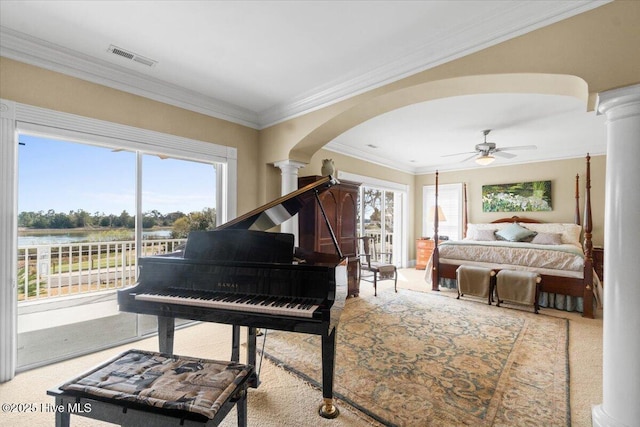 living area featuring ceiling fan, arched walkways, a healthy amount of sunlight, and decorative columns