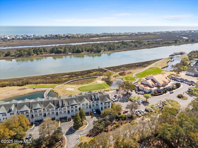 birds eye view of property with golf course view and a water view