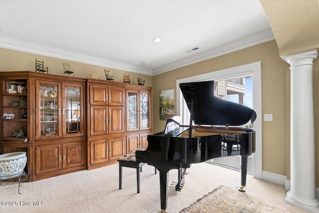 sitting room featuring visible vents, crown molding, ornate columns, and light colored carpet
