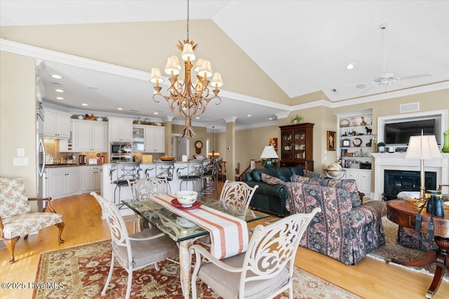 dining room with ceiling fan with notable chandelier, visible vents, recessed lighting, and light wood-style floors