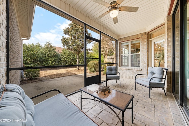 sunroom featuring a ceiling fan