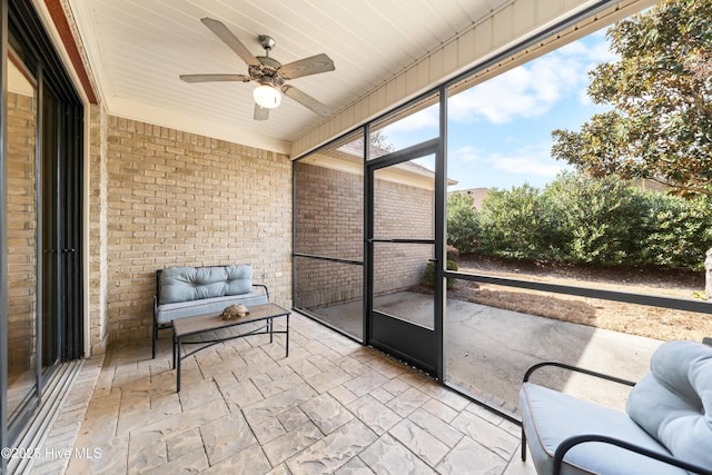 unfurnished sunroom with a ceiling fan