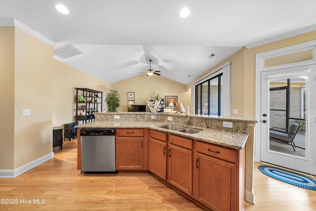 kitchen featuring lofted ceiling, a sink, visible vents, brown cabinets, and dishwasher