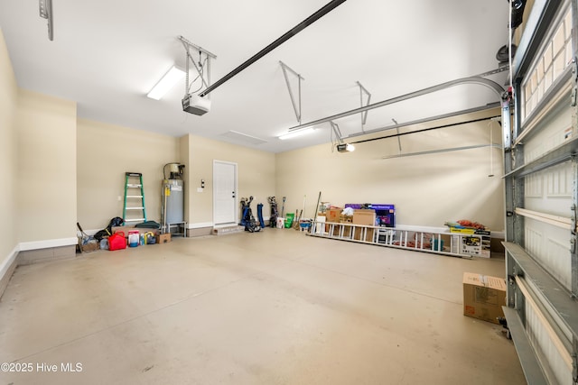 garage featuring strapped water heater, baseboards, and a garage door opener