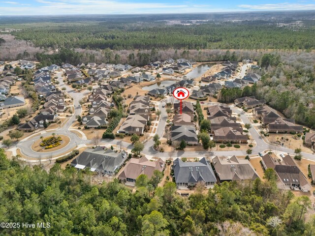 birds eye view of property with a residential view and a forest view