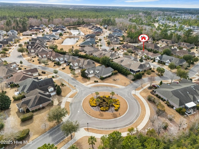 drone / aerial view with a forest view and a residential view