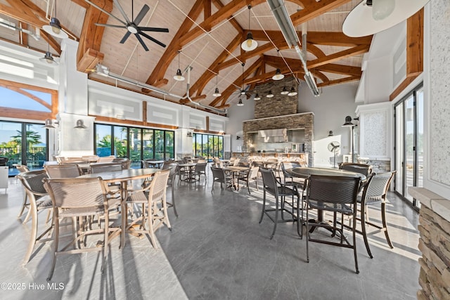 dining space with high vaulted ceiling, beamed ceiling, and a ceiling fan