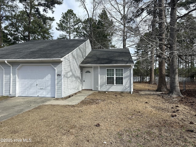 view of front of property with a garage, a shingled roof, and concrete driveway