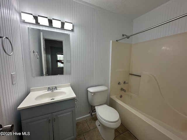 full bathroom featuring toilet, tile patterned floors, tub / shower combination, a textured ceiling, and vanity