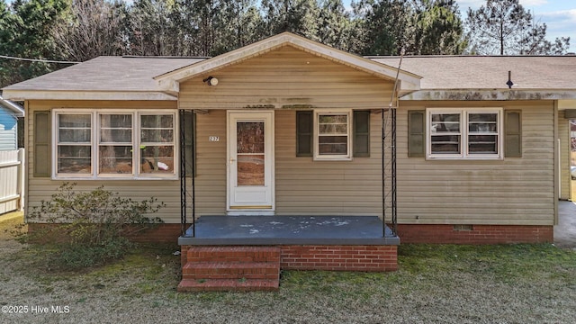 bungalow-style home featuring crawl space and a shingled roof