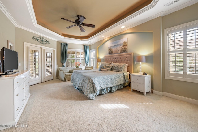 bedroom featuring access to exterior, visible vents, light colored carpet, and a tray ceiling