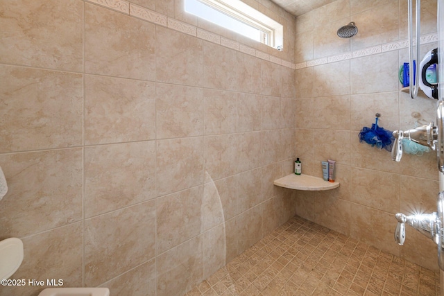 bathroom with tiled shower