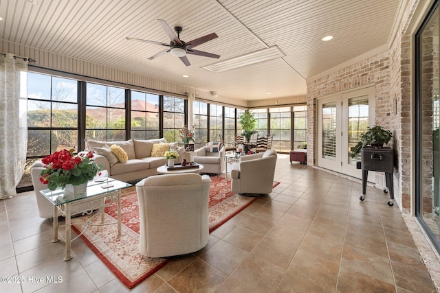 sunroom with wooden ceiling and ceiling fan