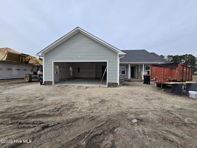 rear view of property with an attached garage