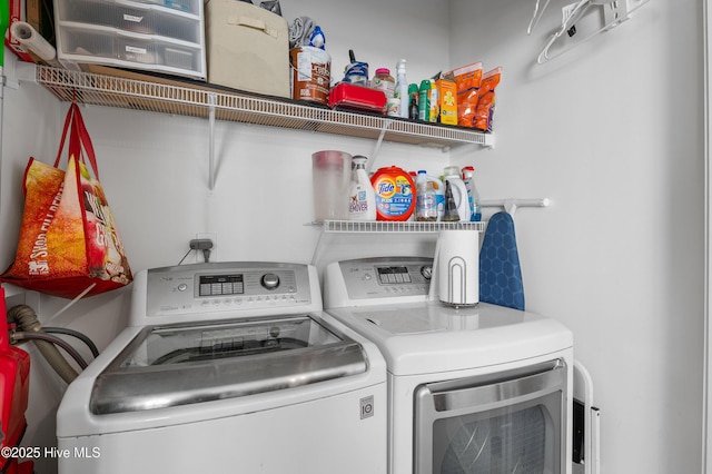 clothes washing area featuring laundry area and separate washer and dryer