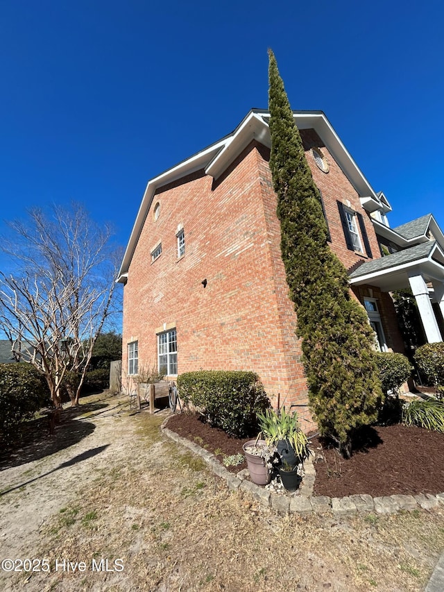 view of home's exterior featuring brick siding