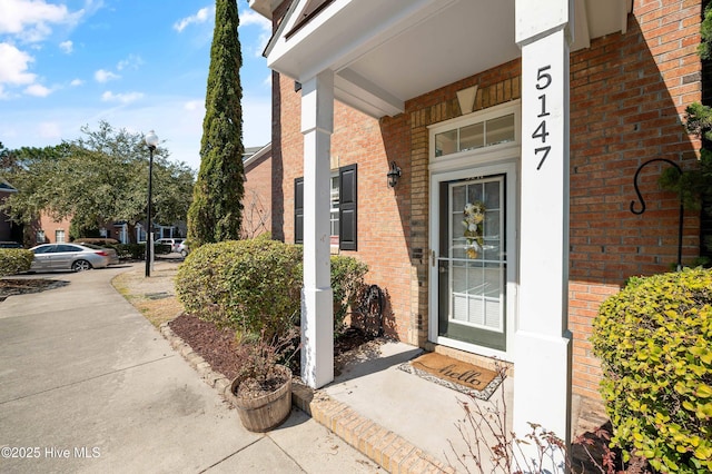 property entrance with brick siding