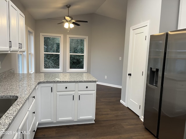 kitchen with lofted ceiling, dark wood-style flooring, stainless steel refrigerator with ice dispenser, and white cabinetry