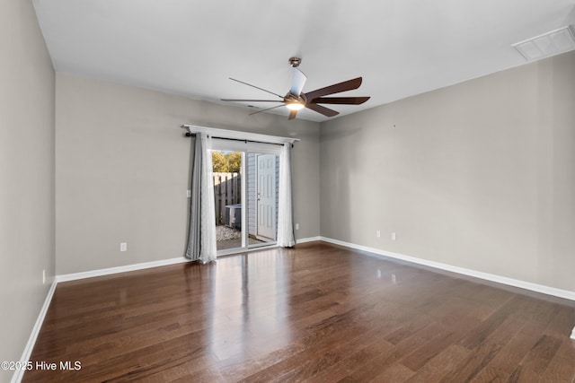 empty room with visible vents, baseboards, and wood finished floors