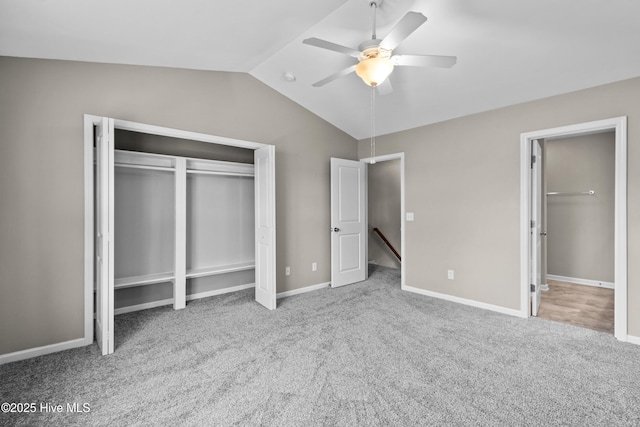 unfurnished bedroom with carpet floors, vaulted ceiling, baseboards, and a ceiling fan