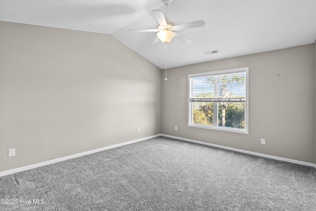 empty room featuring baseboards, visible vents, a ceiling fan, carpet, and vaulted ceiling