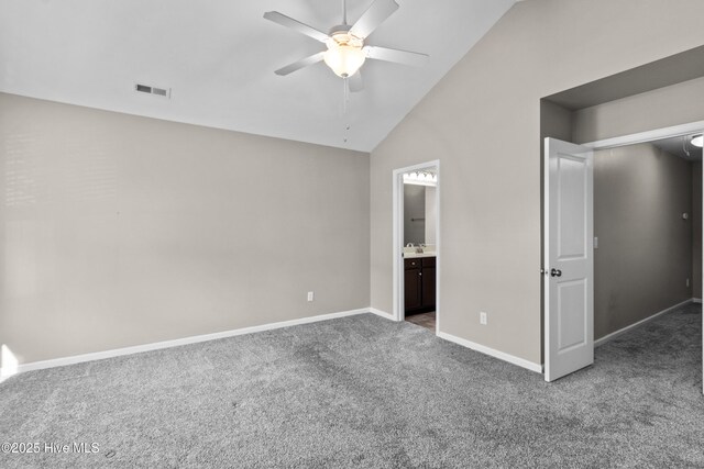 unfurnished bedroom with visible vents, carpet flooring, vaulted ceiling, ensuite bath, and baseboards