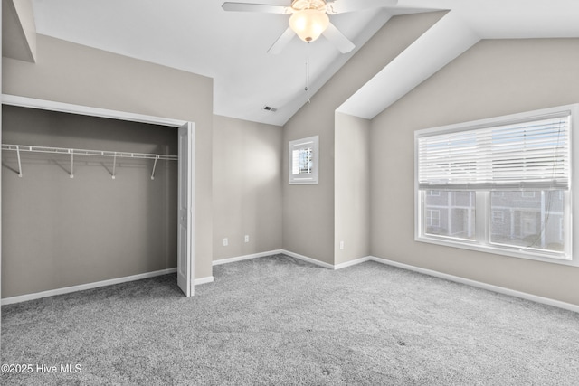 unfurnished bedroom featuring lofted ceiling, carpet floors, a closet, and visible vents