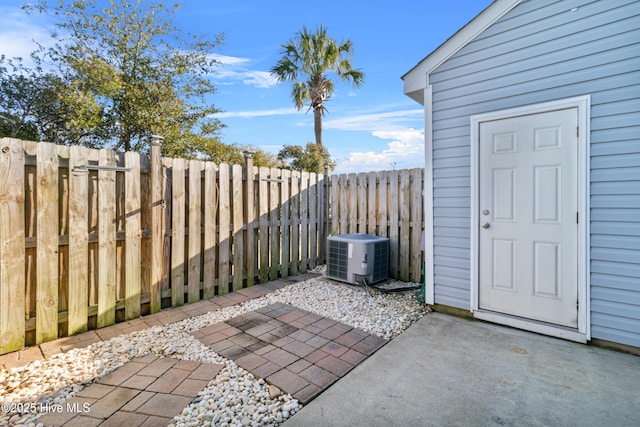 view of patio featuring central air condition unit and a fenced backyard