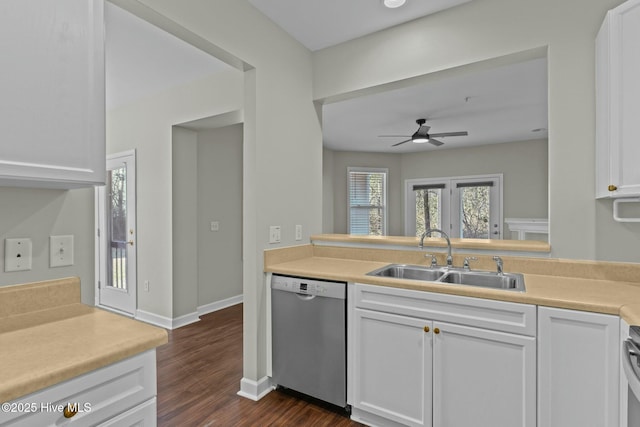 kitchen featuring dark wood-type flooring, a sink, white cabinets, light countertops, and dishwasher