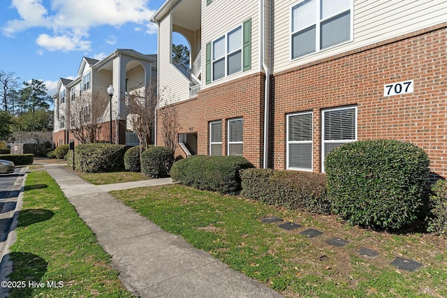 view of side of property featuring brick siding